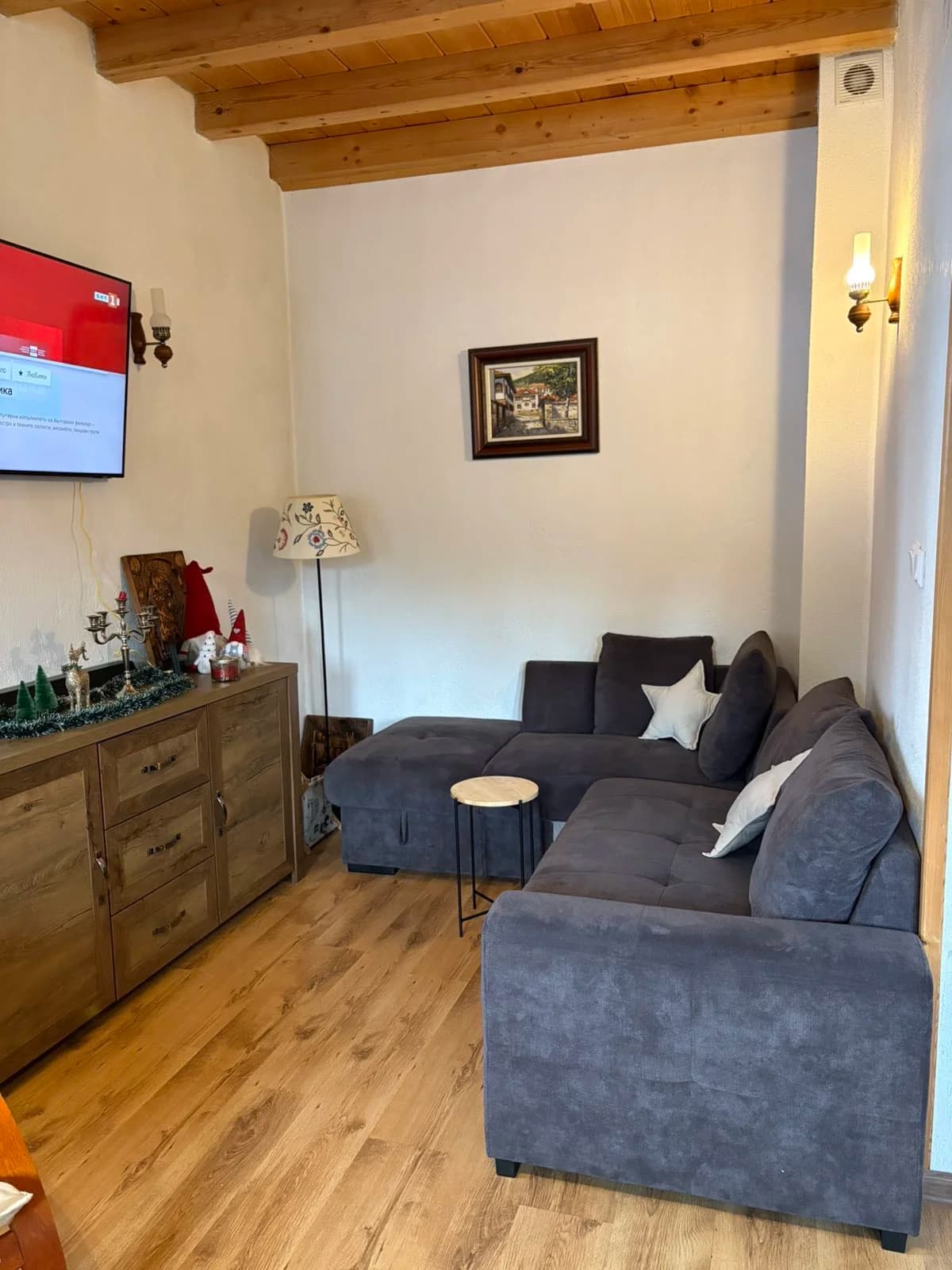 Lounge seating and TV in the common area of House Maria
